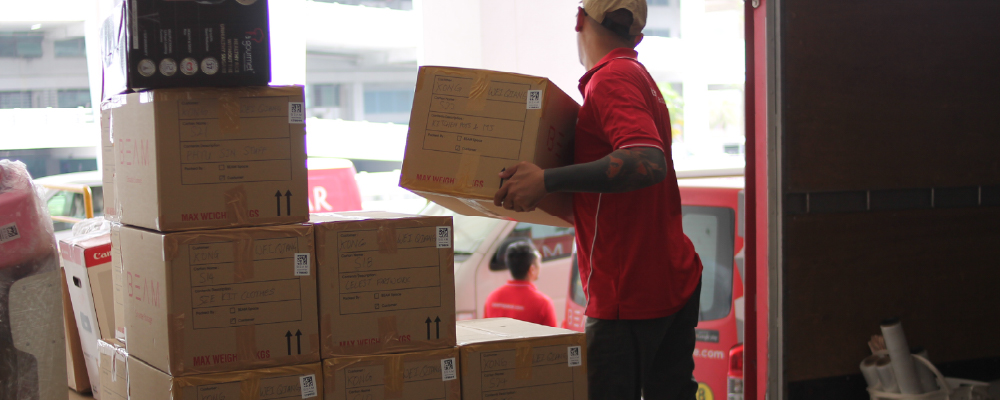 BEAM staff loading office equipment or documents