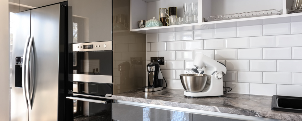 Image of a kitchen with a fridge and other electronic appliances